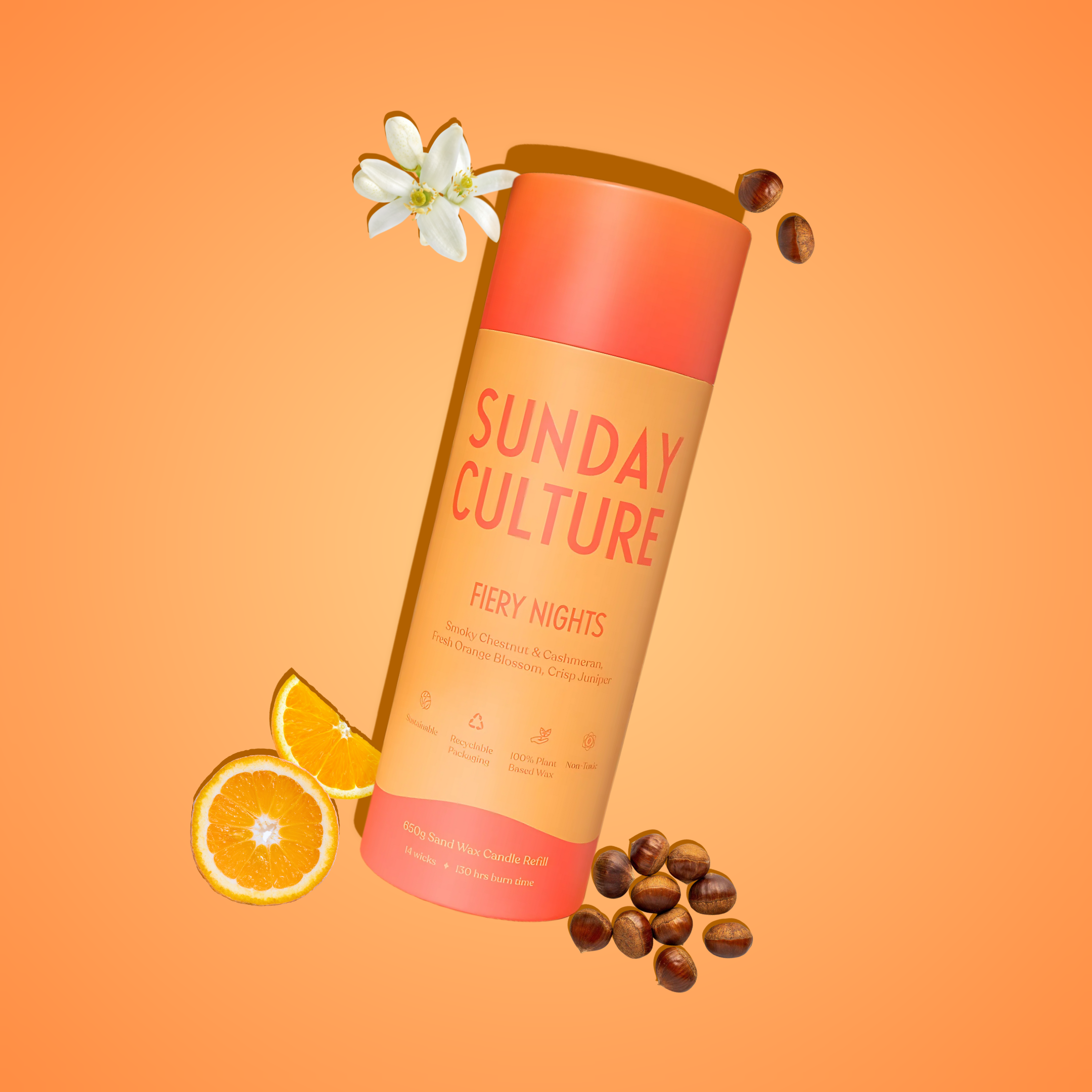 Sunday Culture ready-to-pour sand wax tube on an orange background with oranges and seeds