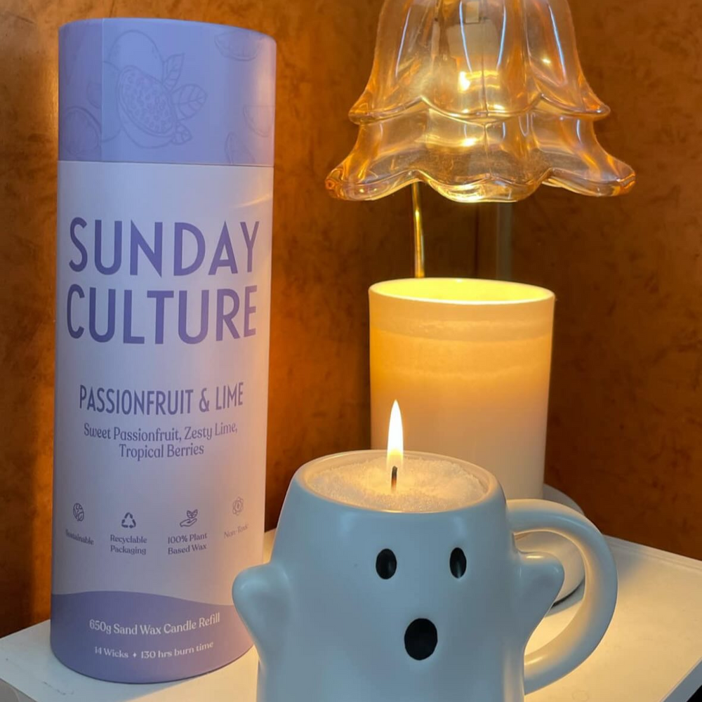 Sand wax candle with 'Sunday Culture' packaging and a ghost-shaped candle holder on a surface.