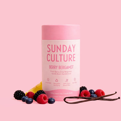 Pink 'Sunday Culture' product with berries and vanilla beans on a pink background